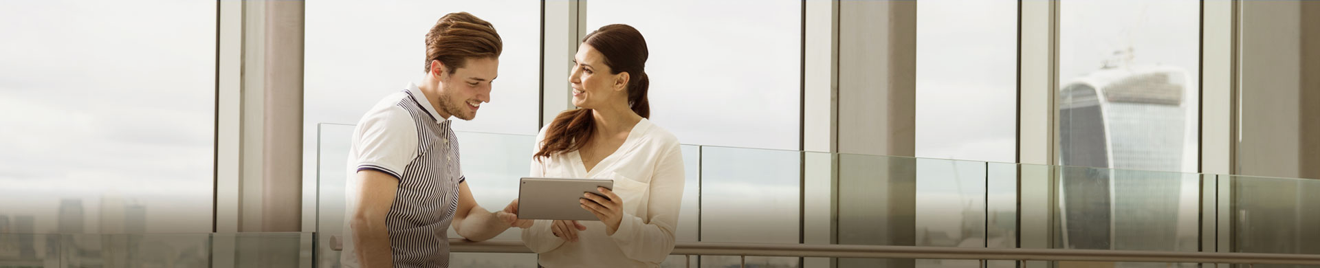 Two people watching the tablet
