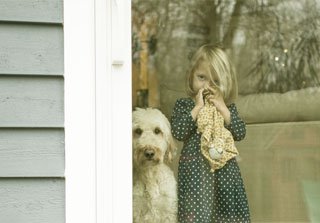 Girl and dog after a picture window